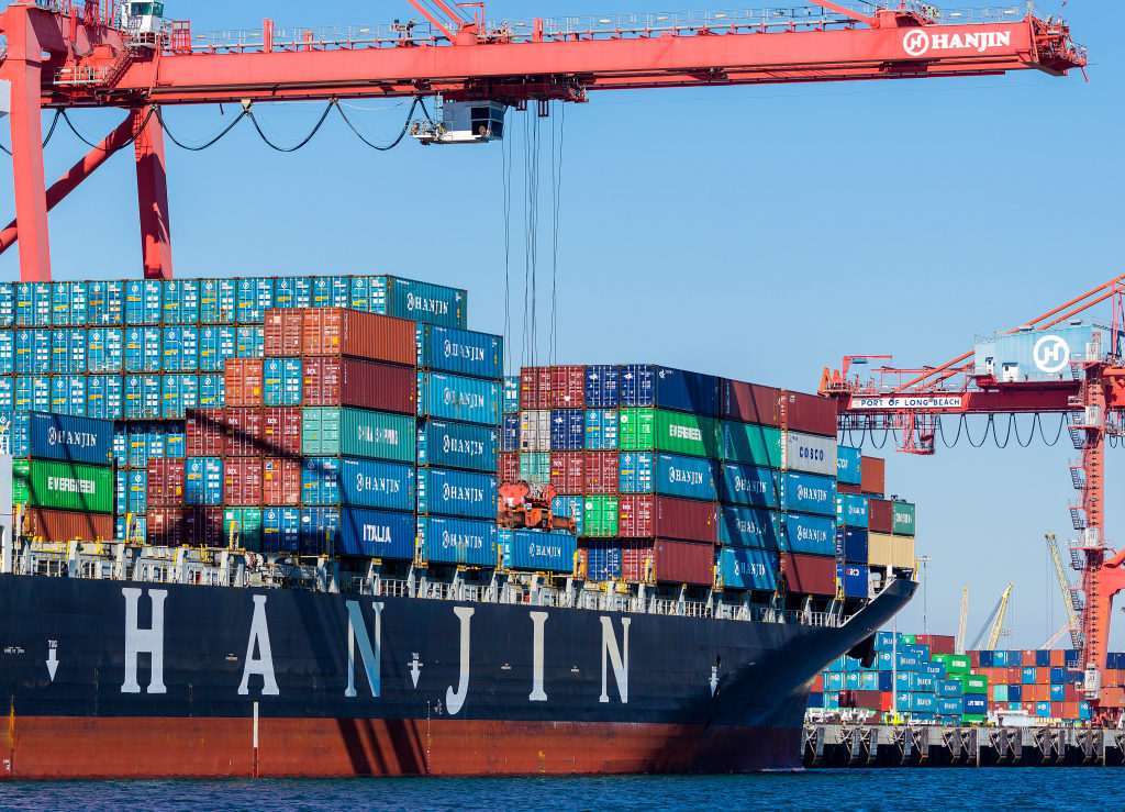 Containers are unloaded from the Hanjin Gdynia cargo ship berthed at the Port of Long Beach in Long Beach, California, U.S., on Thursday, Sept. 15, 2016. Bankrupt Hanjin Shipping Co.'s efforts to unload vessels in the U.S. while it goes through bankruptcy in South Korea are meeting with complaints from cargo owners and from the companies that service and equip its fleet. Photographer: Tim Rue/Bloomberg via Getty Images